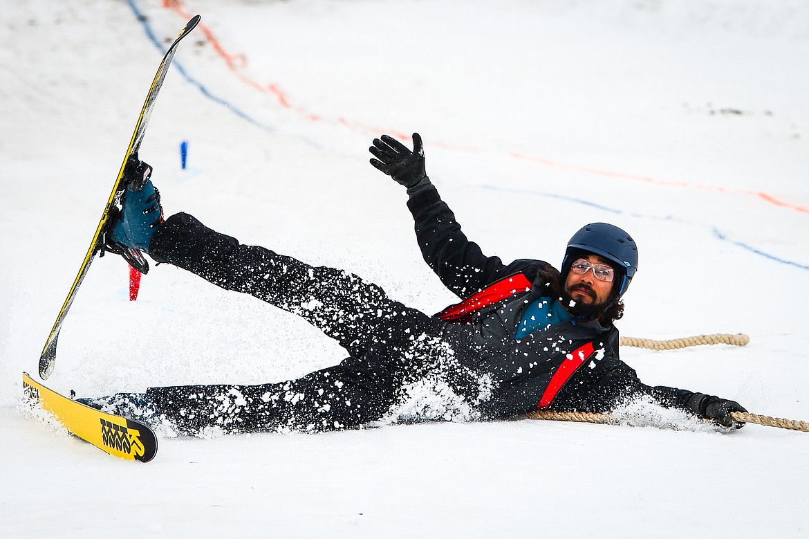 Skier Alex Stevens hangs on to the rope as his horse and rider pull him to the finish line at Whitefish Ski Joring on Saturday, Feb. 19. (Casey Kreider/Daily Inter Lake)