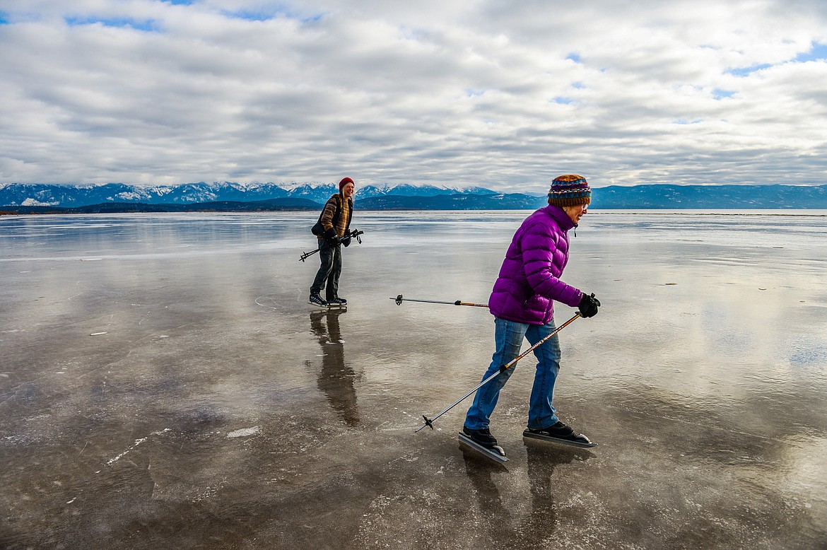 Helen Pilling, left, and Leslie Dillon ice skate on the frozen surface of Somers Beach along the north shore of Flathead Lake on Wednesday, Jan. 19. (Casey Kreider/Daily Inter Lake)