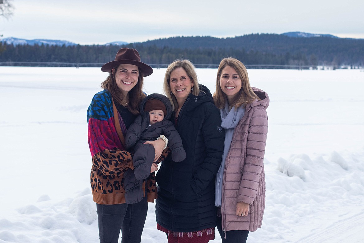 Carolyn Kohrs, center, stands for a portrait with her children, Clara, left, Clara's son, Quinn, and Hannah, right, on the Kohrs family land on Jan 5, 2023. (Kate Heston/Daily Inter Lake)