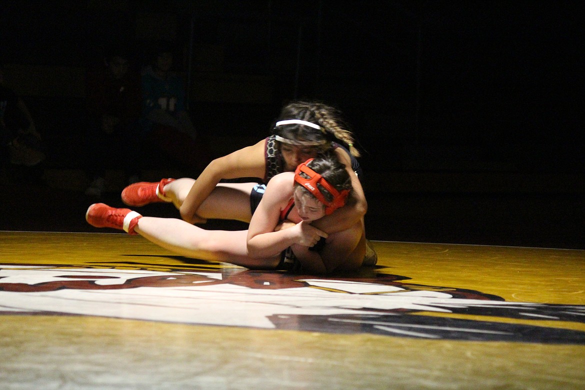 Gabriela Vela, Moses Lake, top, works against Sydney Masengale of West Valley (Yakima) in Wednesday’s dual meet.