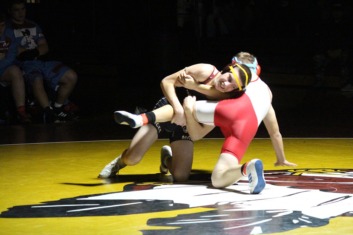 Moses Lake’s Blake Stowe, left, tries to turn his opponent, Tanner Spaeth of West Valley (Yakima).