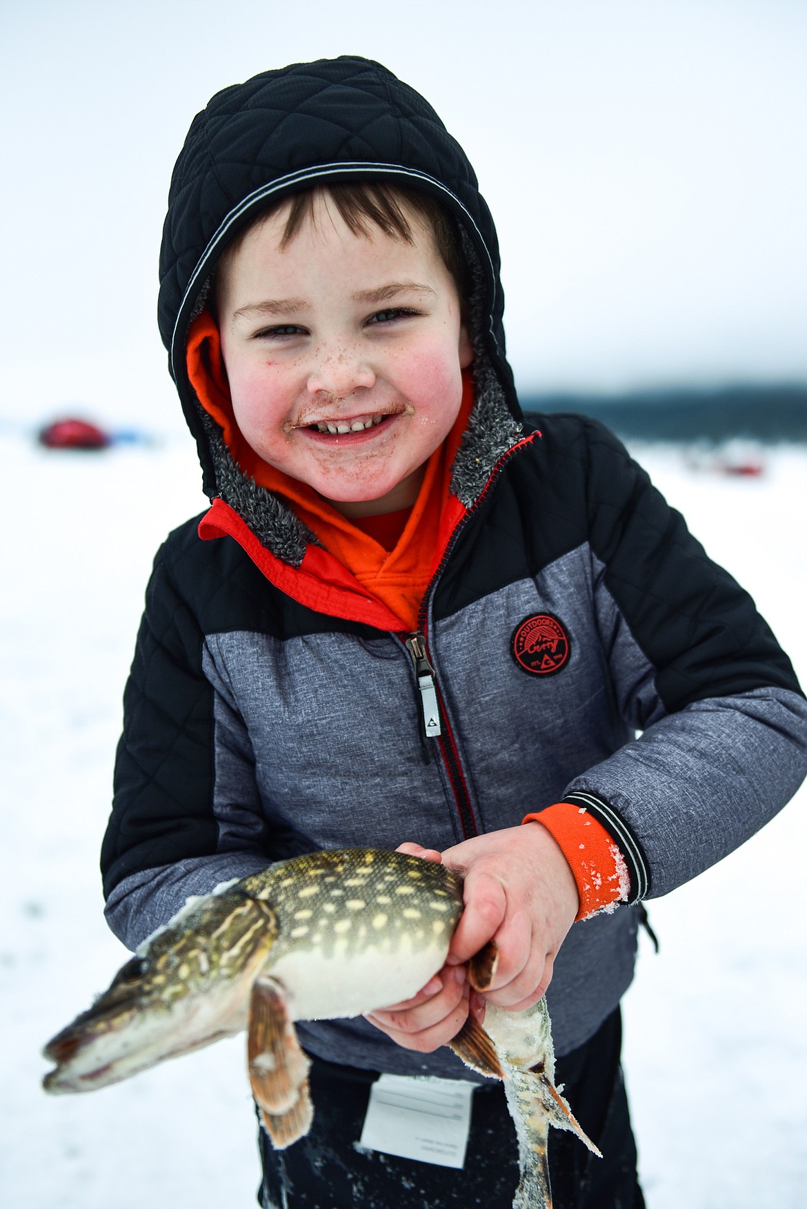 Colton Reynolds holds a pike he caught at the Sunriser Lions Family Ice Fishing Derby at Smith Lake on Saturday, Jan. 7. (Casey Kreider/Daily Inter Lake)