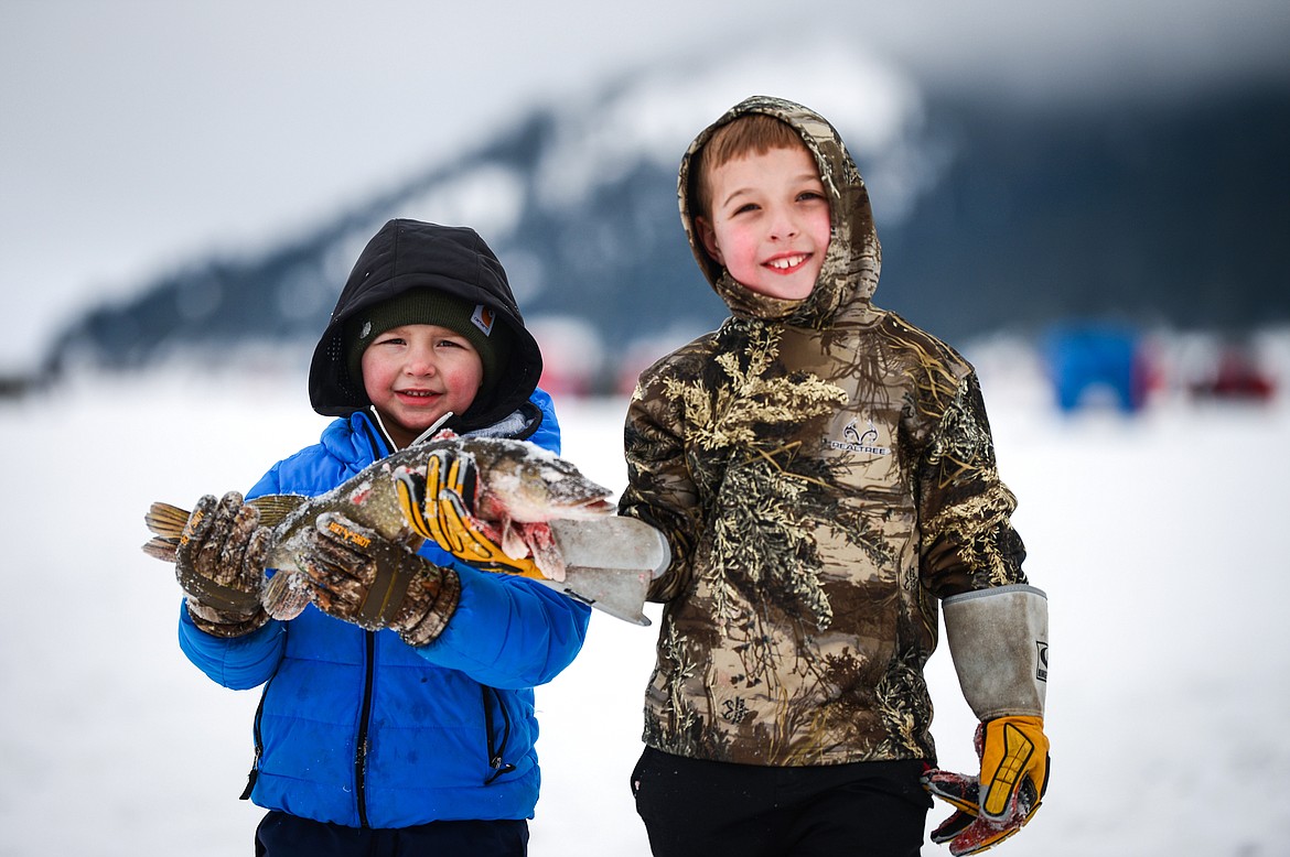 Emmett Dopps and Cedar Keller hold a pike they reeled in together at the Sunriser Lions Family Ice Fishing Derby at Smith Lake on Saturday, Jan. 7. (Casey Kreider/Daily Inter Lake)