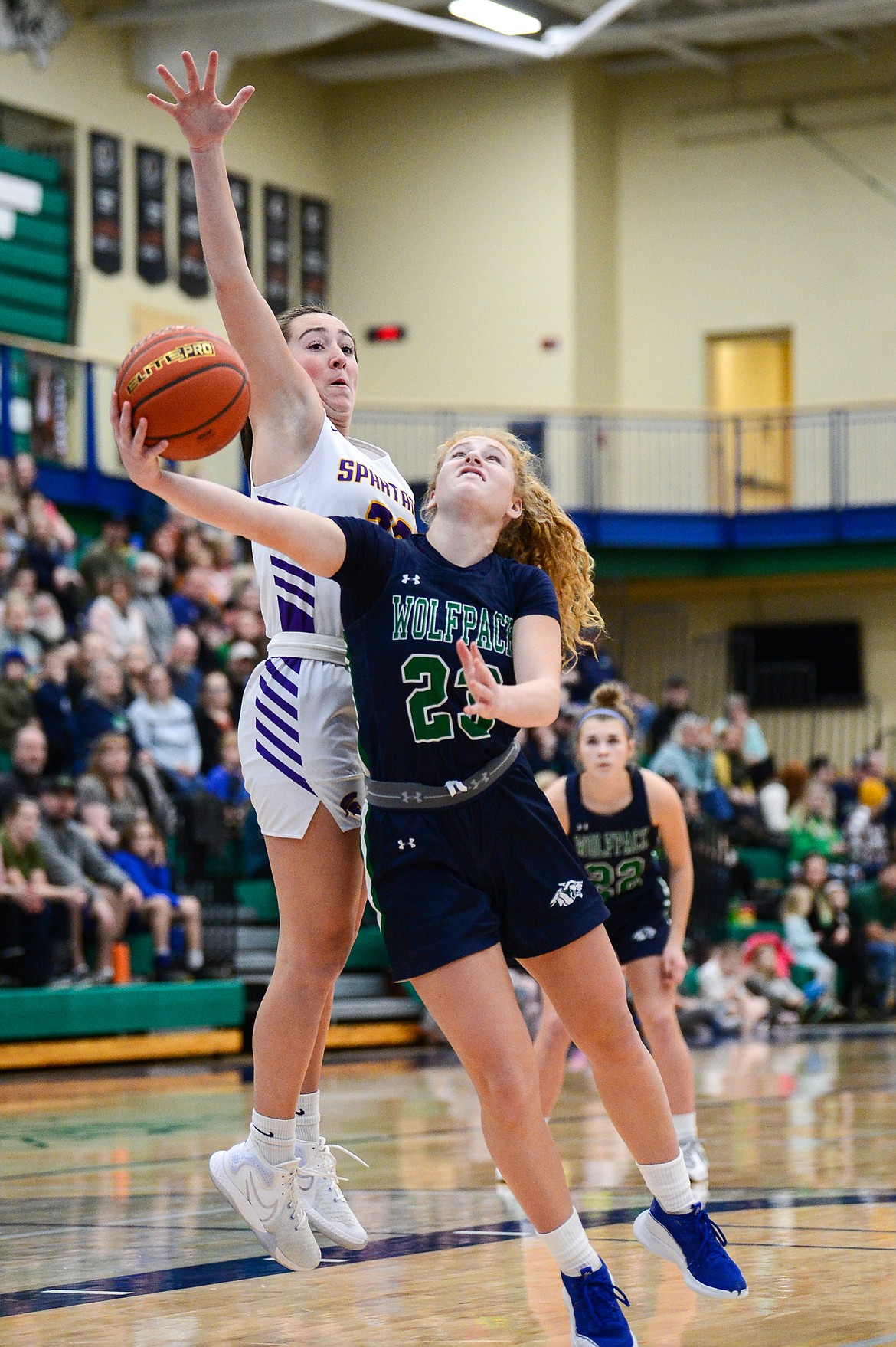 Glacier's Reese Ramey (23) drives to the basket past Missoula Sentinel's Kassidy Kirgan (33) in the first half at Glacier High School on Saturday, Jan. 7. (Casey Kreider/Daily Inter Lake)