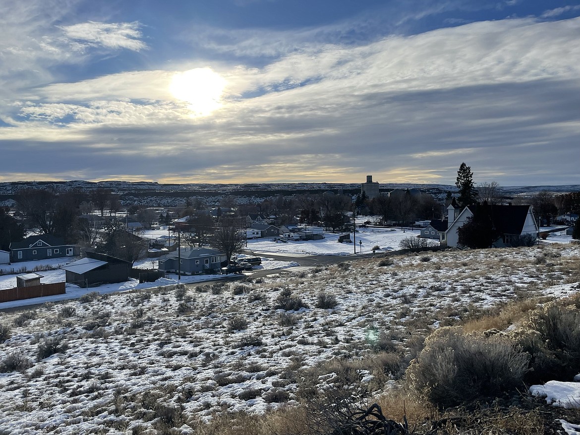 A winter sun shines through the clouds over Wilson Creek, as seen from the Wilson Creek School on Thursday.