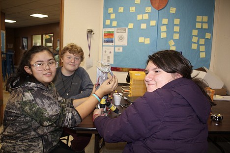 Making the robot smaller in size for easier maneuverability and programming is what 7th grade students Michayla Hansen, Evan Fehlings and Mekynzie Dittmer are designing. A streamlined version of their first model should score higher in the state competition in Butte next month. (Photo provided)