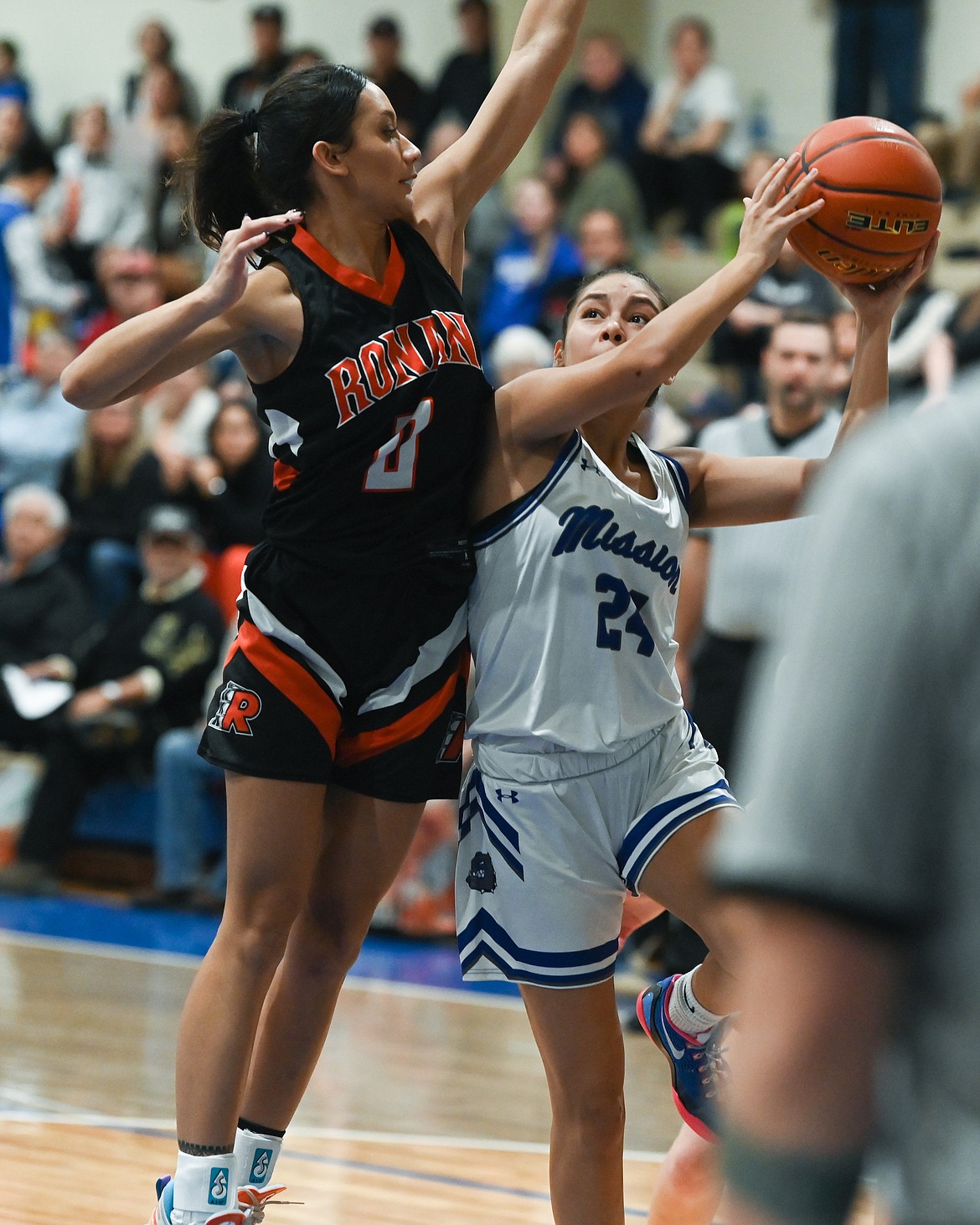 Ronan's Leina Ulutoa tries to stop a shot by Mission's Elannah Flat Lip. (Photo by Christa Umphrey)