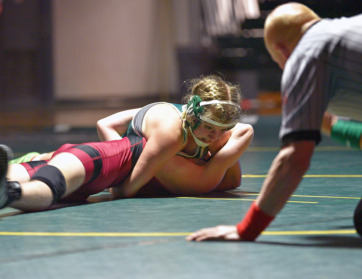 Whitefish freshman Sam Bennetts takes down her opponent from Hamilton in a dual on Thursday at Whitefish High School. (Whitney England/Whitefish Pilot)