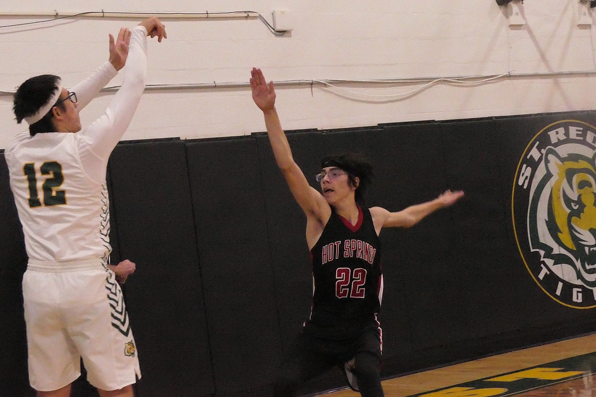 St.Regis' Ayden Rael shoots over Hot Springs' Austin Campbell during the Tigers home win over the Savage Heat Thursday night. (Chuck Bandel/VP-MI)