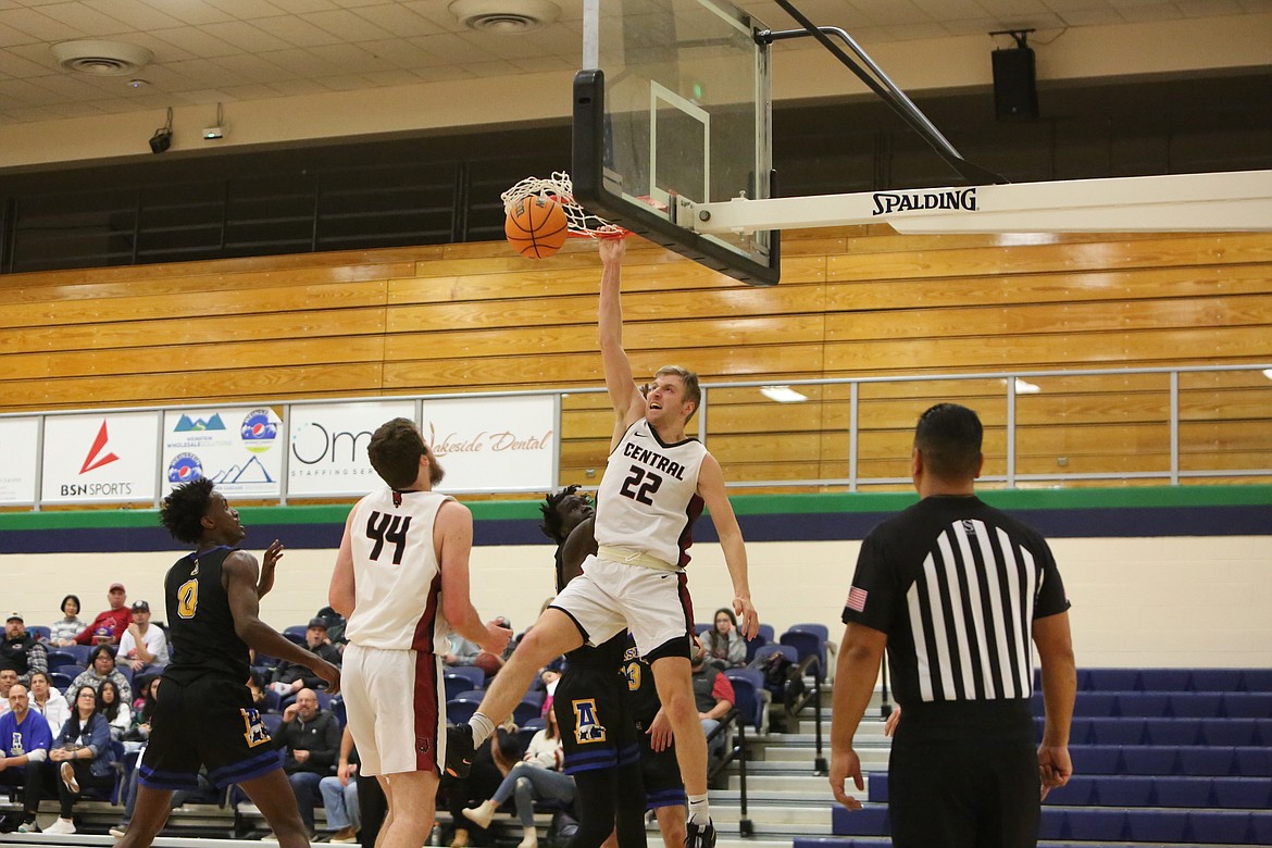 Central Washington sophomore guard Colby Gennett rises up for a dunk over Alaska Fairbanks defenders.