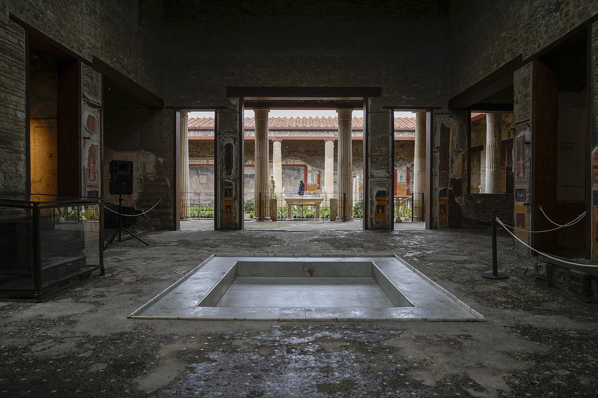 A view of the impluvium, the rain water-catchment pool in the atrium of the Ancient Roman Domus Vettiorum, House of Vettii, in the Pompeii Archeological Park, near Naples, southern Italy, Wednesday, Dec. 14, 2022. One of Pompeii's most famous and richest domus, which contains exceptional works of art and tells the story of the social ascent of two former slaves, is opening its doors to visitors Wednesday, Jan. 11, 2023 after 20 years of restoration. (AP Photo/Andrew Medichini)