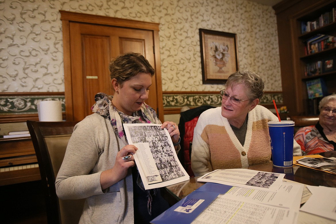Public historian Sara Jane Ruggles shows Dina Mills-Hourlland where a photo of her great uncle, Charlie Mellor, is found in a 1945 report chronicling the events of the Wake Island takeover by the Japanese military in 1941. Mellor's family connected Tuesday with another local family, the Newells, after Ruggles discovered both families had loved ones taken together as POWs from Wake Island.