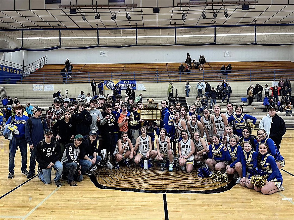 Libby Public School students pose with the Highway 37 Battle of the Kootenai trophy Tuesday night after the boys basketball and wrestling beat Eureka to reclaim the trophy. (Scott Shindledecker/The Western News)