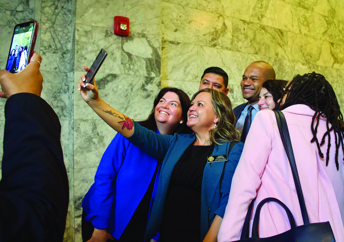 State Rep. Tarra Simmons, D-Bremerton, snaps a selfie with friends and associates on the opening day of the State Legislature, Jan. 9.