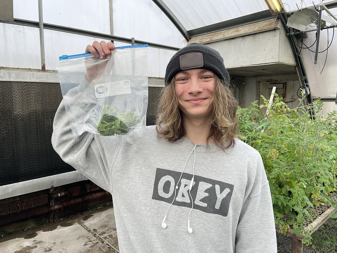 Owen Freeman holds up some broccoli he’s grown as part of a Moses Lake High School horticulture class. “I do like my veggies,” he said.