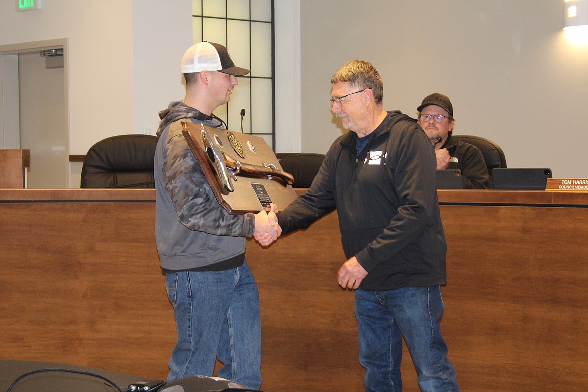 Retiring Grant County Fire District 3 Assistant Chief Jim Kling, right, receives a plaque, presented by firefighter/EMT Casey Severin, left, from GCFD 3 in appreciation of his 34 years of service to the district at the Jan. 3 Quincy City Council meeting.