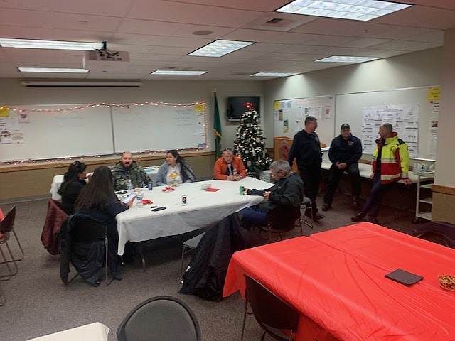 Jim Kling, third from right, talks to attendees at his retirement party in December.