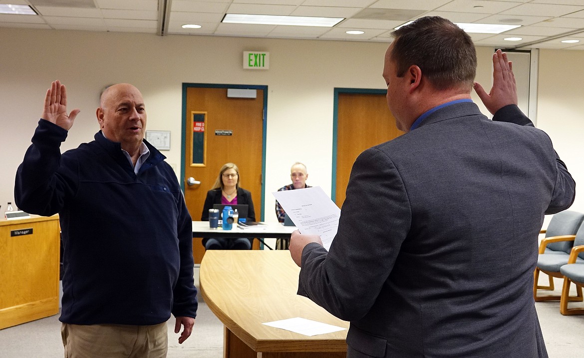 Grant County PUD Commissioner Terry Pyle, left, is sworn in by Grant County Superior Court Judge Tyson Hill for a new term.