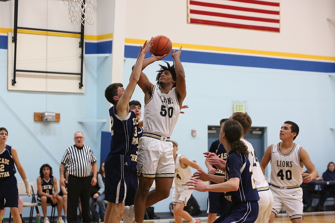 MLCA/CCS junior Caleb Love (50) rises up for a jump shot in the first half of the Lion’s 57-19 win over Cascade Christian Academy on Thursday.