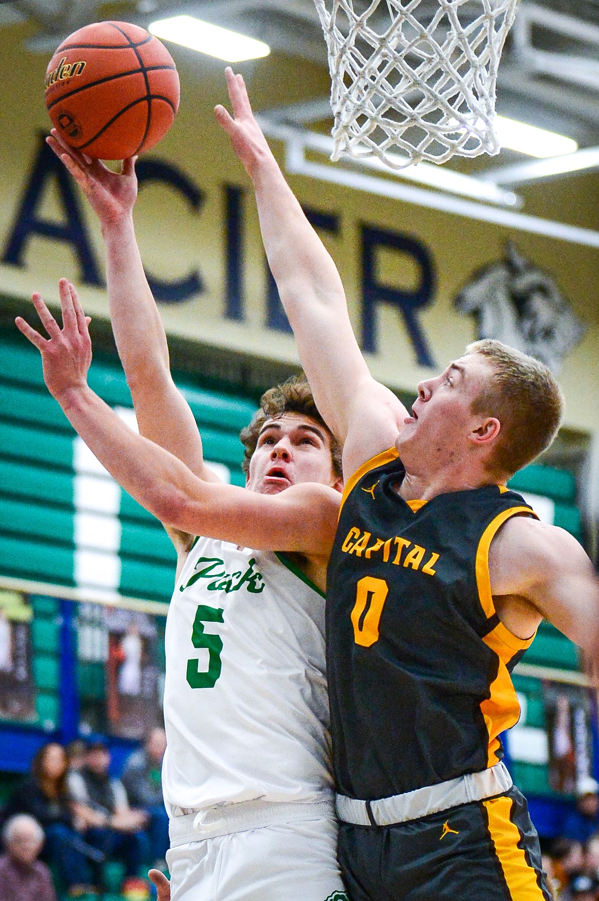 Glacier's Ty Olsen (5) drives to the basket against Helena Capital's Hayden Opitz (0) in the first quarter at Glacier High School on Friday, Jan. 13. (Casey Kreider/Daily Inter Lake)