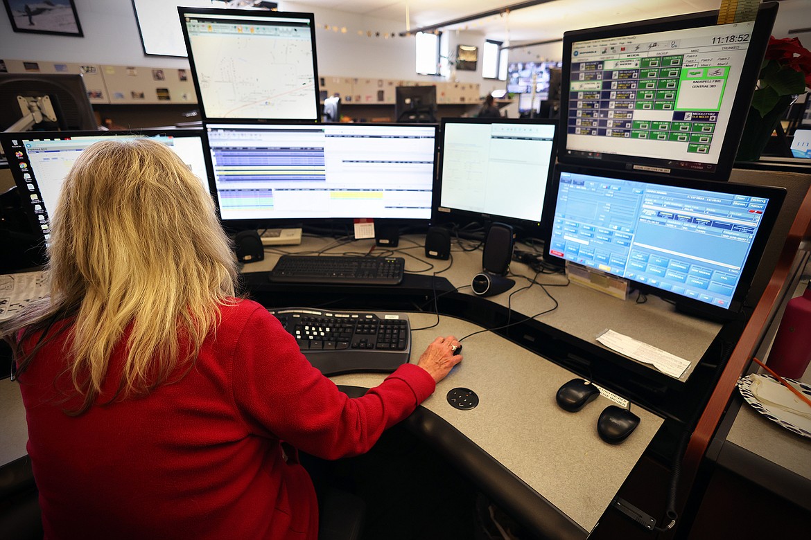 A dispatcher works at her station at the Flathead Emergency Communication Center Friday, Jan. 13. Workers at the understaffed center have been putting in extra hours for more than a year as the county struggles to fill vacant positions. (Jeremy Weber/Daily Inter Lake)