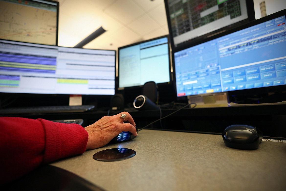 A dispatcher works at her station at the Flathead Emergency Communication Center Friday, Jan. 13. Workers at the understaffed center have been putting in extra hours for more than a year as the county struggles to fill vacant positions. (Jeremy Weber/Daily Inter Lake)