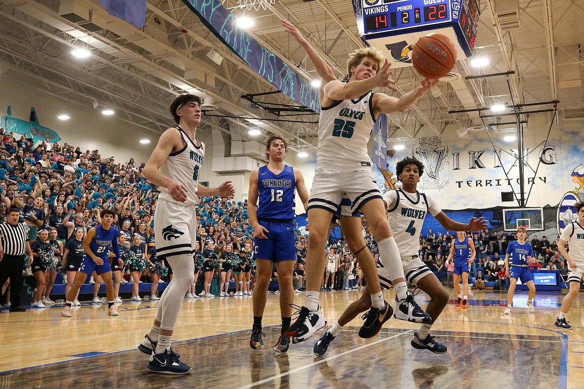 JASON DUCHOW PHOTOGRAPHY
Nathan Hocking (25) of Lake City grabs a rebound as Blake Buchanan (0) of Lake City, Alexander Nipp (12) of Coeur d'Alene and Cason Miller (4) of Lake City look on during the boys Fight for the Fish spirit game Friday night at Coeur d'Alene High.