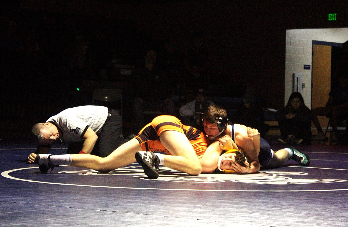 Marcus Regher works to pin his Lincoln High School opponent on Jan. 12.