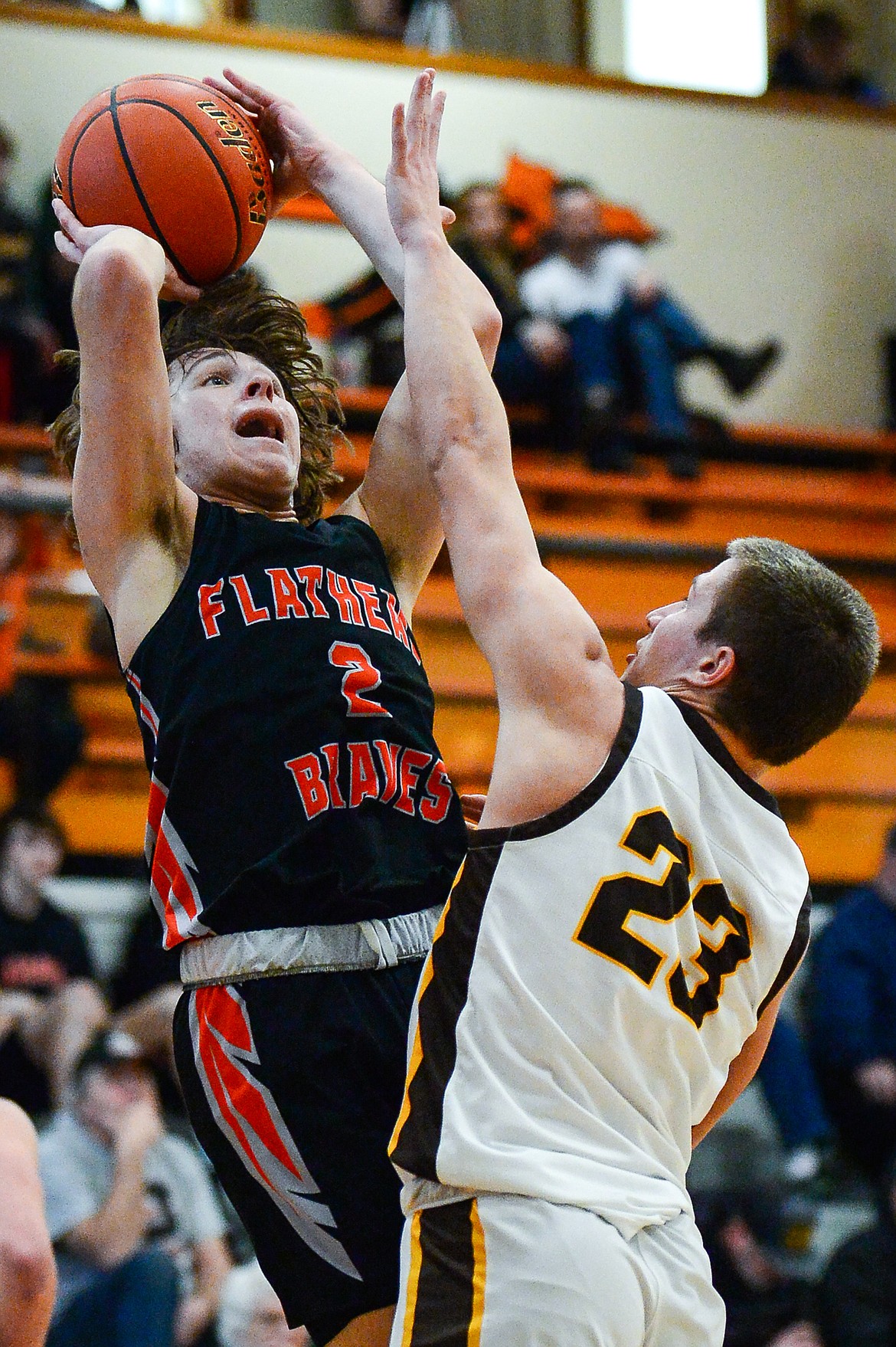 Flathead's Joshua Eagleton (2) knocks down a jumper over Helena Capital's Tyler Kovick in the first half at Flathead High School on Saturday, Jan. 14. (Casey Kreider/Daily Inter Lake)