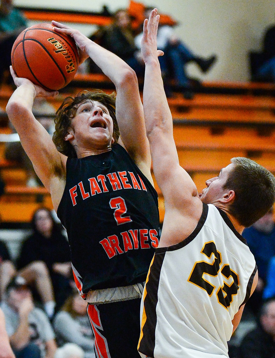 Flathead's Joshua Eagleton (2) knocks down a jumper over Helena Capital's Tyler Kovick in the first half at Flathead High School on Saturday, Jan. 14. (Casey Kreider/Daily Inter Lake)