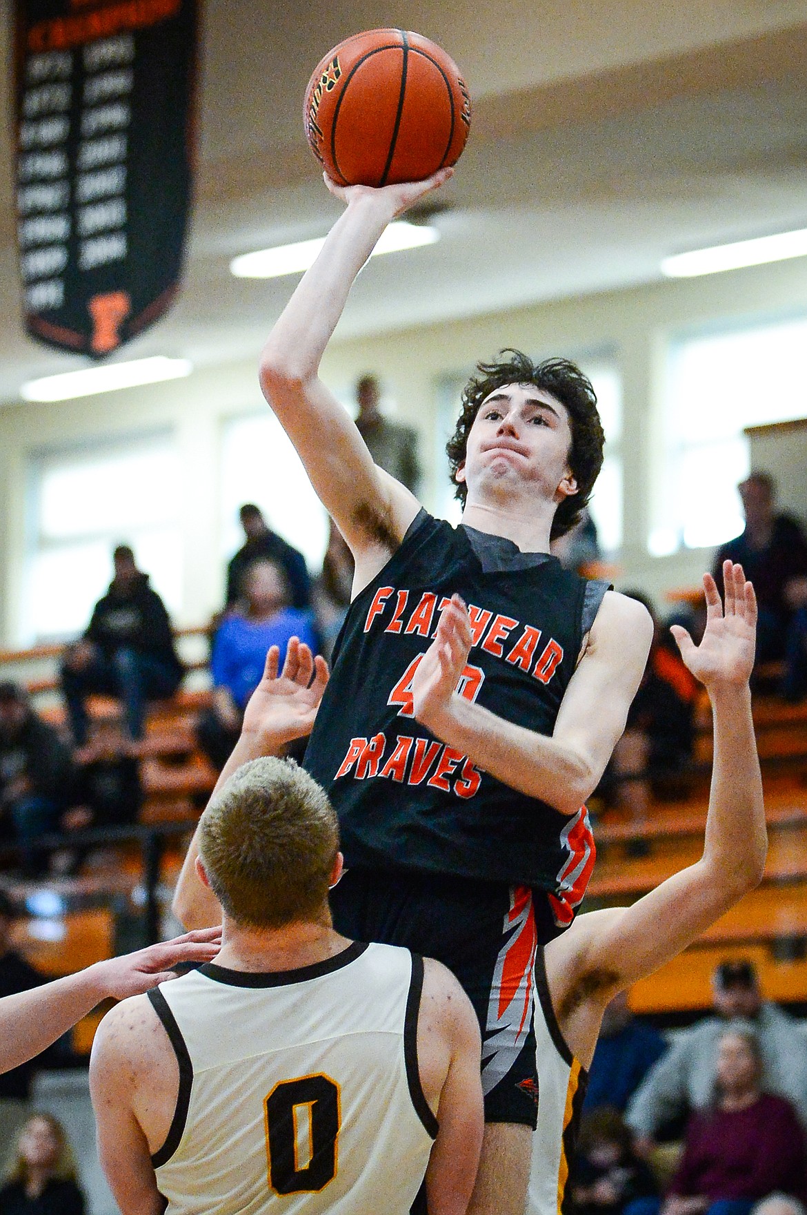 Flathead's Noah Cummings (40) drives to the basket against Helena Capital's Hayden Opitz (0) in the third quarter at Flathead High School on Saturday, Jan. 14. (Casey Kreider/Daily Inter Lake)