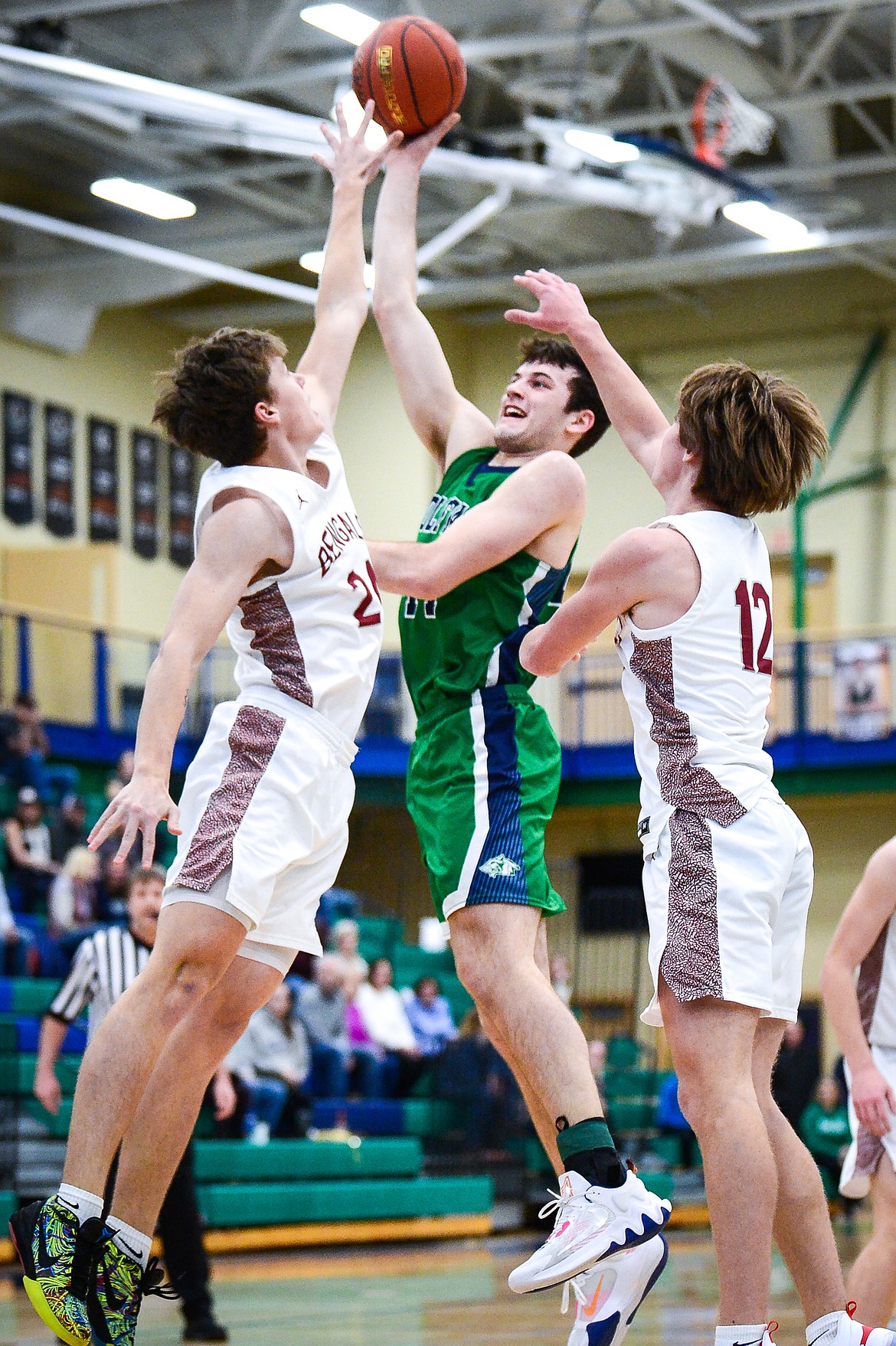 Glacier's Noah Dowler (44) shoots in the lane between Helena High's  Cael Murgel (24) and Dylan Mosness (12) in the first half at Glacier High School on Saturday, Jan. 24. (Casey Kreider/Daily Inter Lake)