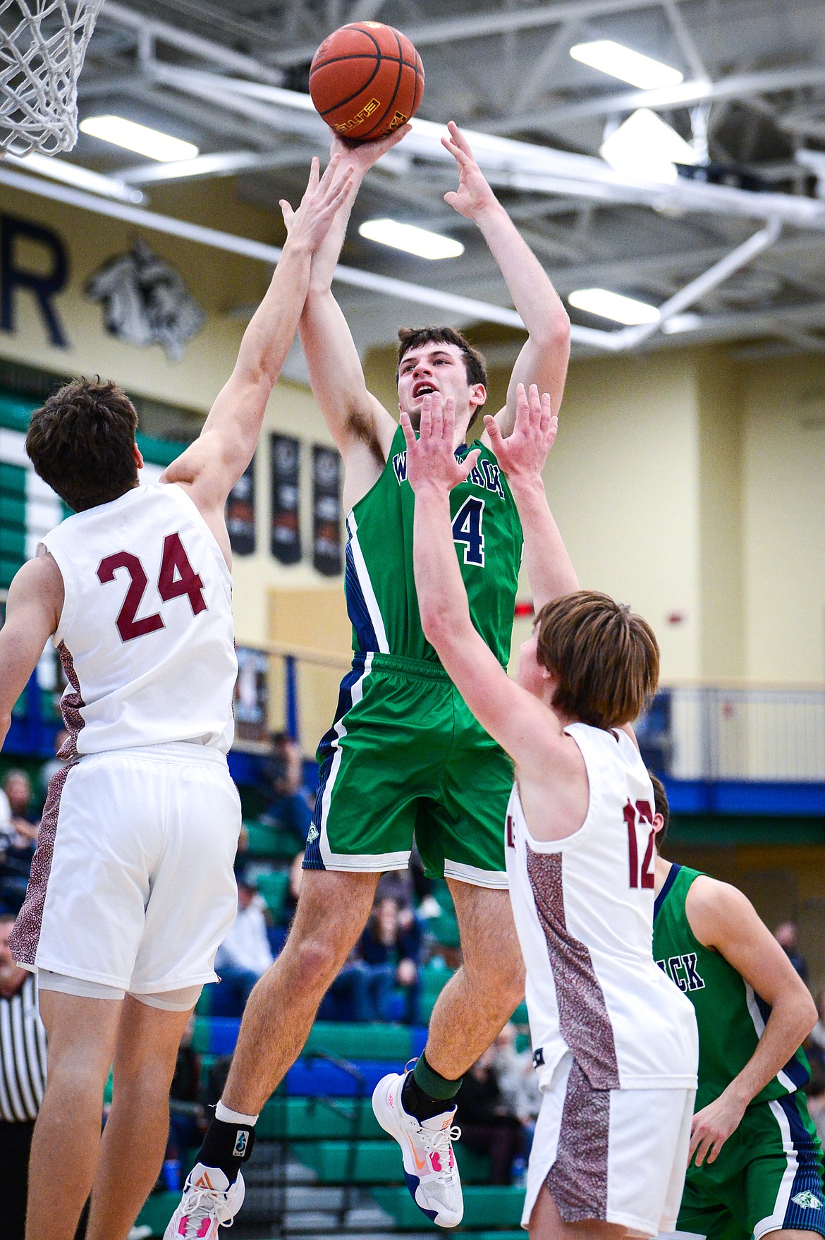 Glacier's Noah Dowler (44) shoots in the lane between Helena High's  Cael Murgel (24) and Dylan Mosness (12) in the first half at Glacier High School on Saturday, Jan. 24. (Casey Kreider/Daily Inter Lake)