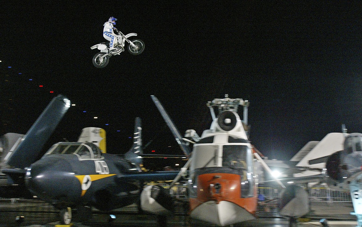 FILE - Motorcycle daredevil Robbie Knievel, the son of daredevil Evel Knievel, soars over seven vintage aircraft on the flight deck of the USS Intrepid Sea, Air and Space Museum in New York on July 31, 2004. Knievel, an American stunt performer, died early Friday at a hospice in Reno, Nev., with his daughters at his side, his brother Kelly Knievel said. He was 60. (AP Photo/Stuart Ramson, File)