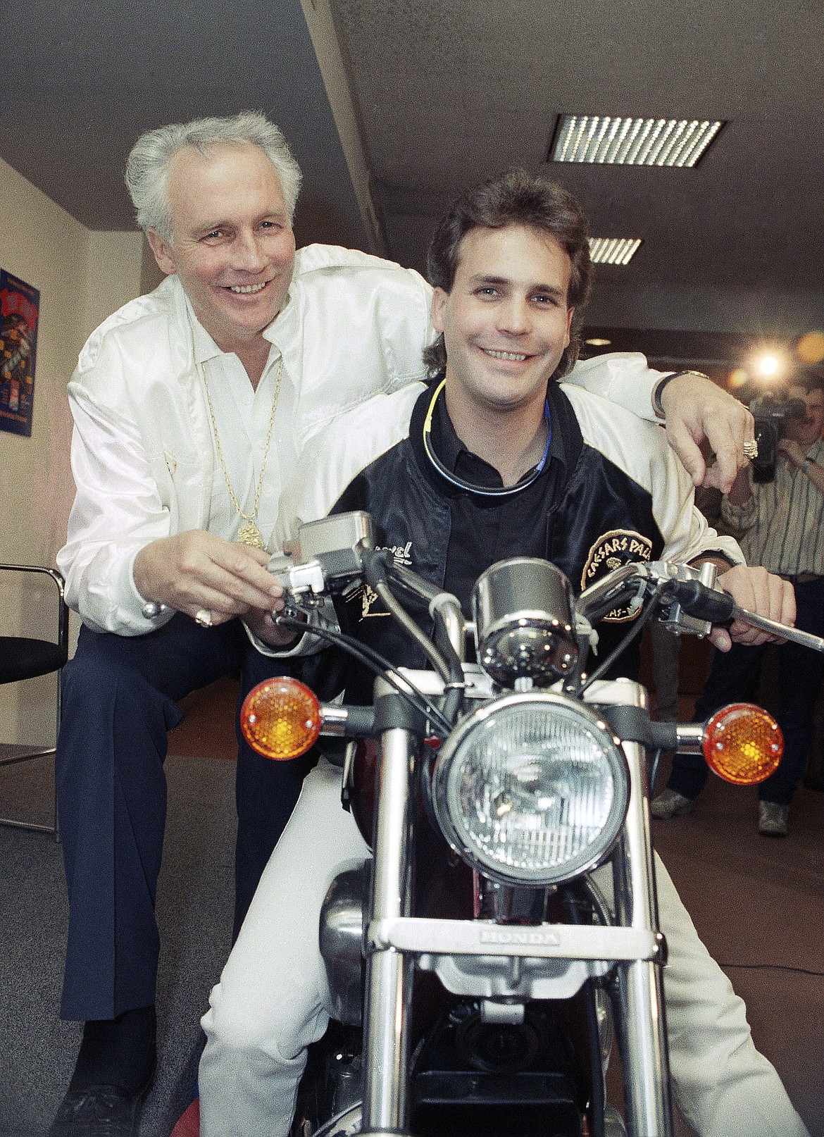 FILE - Motorcycle daredevil Robbie Knievel, right, poses with his famous father, Evel Kneivel, at a New York news conference on March 27, 1989. Robbie Knievel, an American stunt performer, died early Friday at a hospice in Reno, Nev., with his daughters at his side, his brother Kelly Knievel said. He was 60. Evel Knievel died in 2007. (AP Photo/Marty Lederhandler, File)