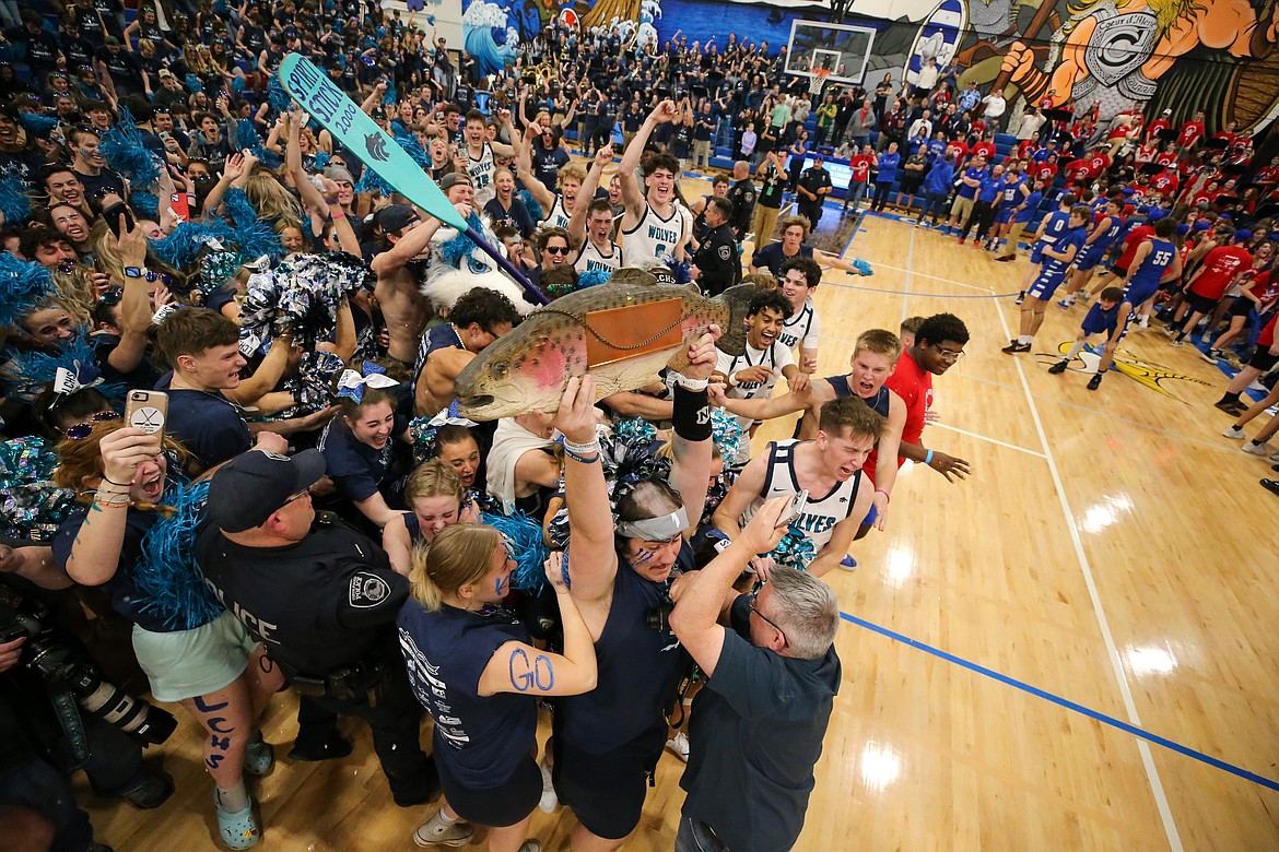 JASON DUCHOW PHOTOGRAPHY
Lake City High ASB president Jacob Carter holds the trophy aloft as students and players alike celebrate after Lake City won the Fight for the Fish spirit competition Friday night at Coeur d'Alene High. The event included boys and girls basketball games between Coeur d'Alene and Lake City high schools, and was held for the 23rd time, but the first since 2020 because of the COVID-19 pandemic.