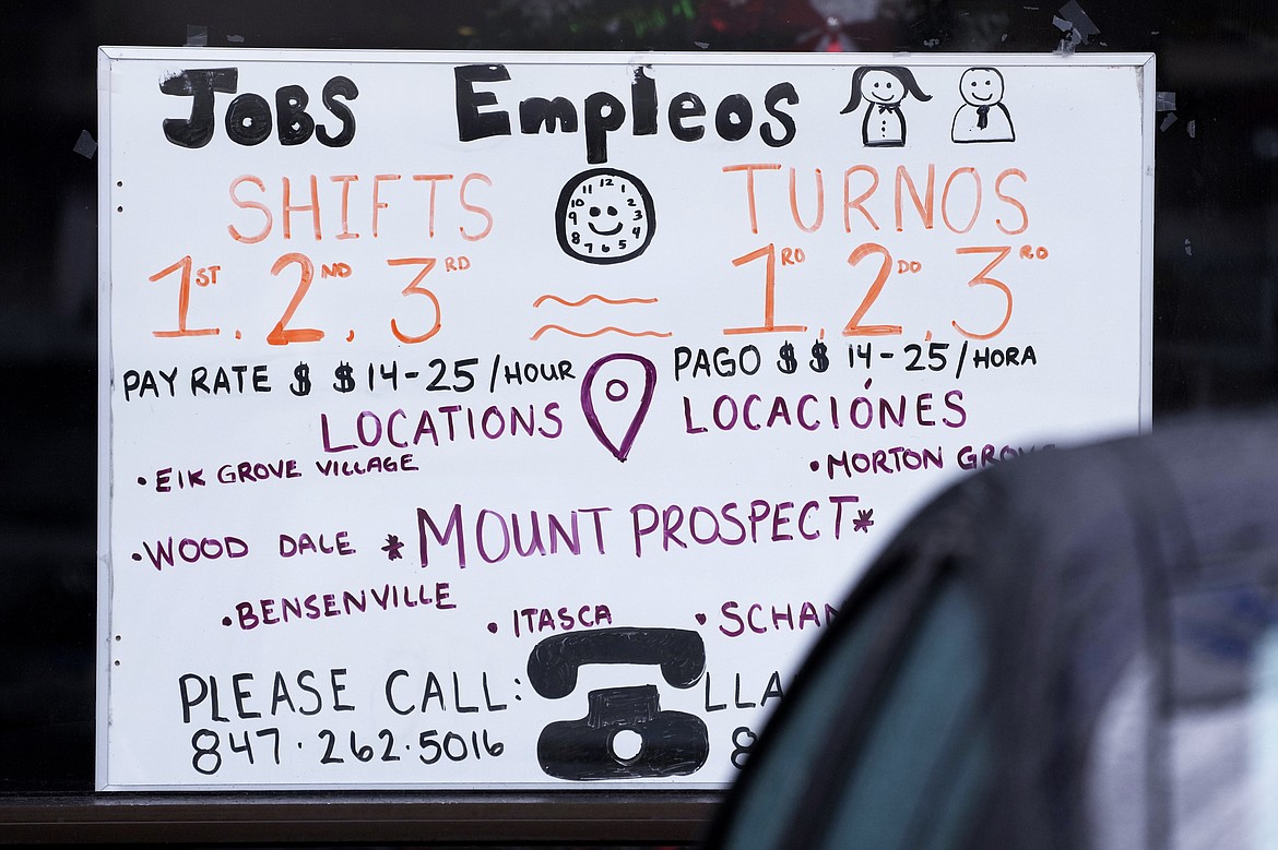 File - A hiring sign is displayed at a job agency in Mount Prospect, Ill., Thursday, Jan. 3, 2023. An economic downturn remains very possible. Yet in recent weeks, with inflation showing widespread signs of easing, a more cheerful view has begun to gain traction: Maybe a recession isn't inevitable after all.(AP Photo/Nam Y. Huh, File)