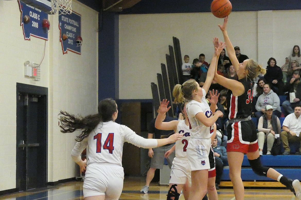 Hot Springs forward Lauryn Aldridge (34) shoots over Superior's Payton Milender during their game Saturday night in Superior.  (Chuck Bandel, VP-MI)