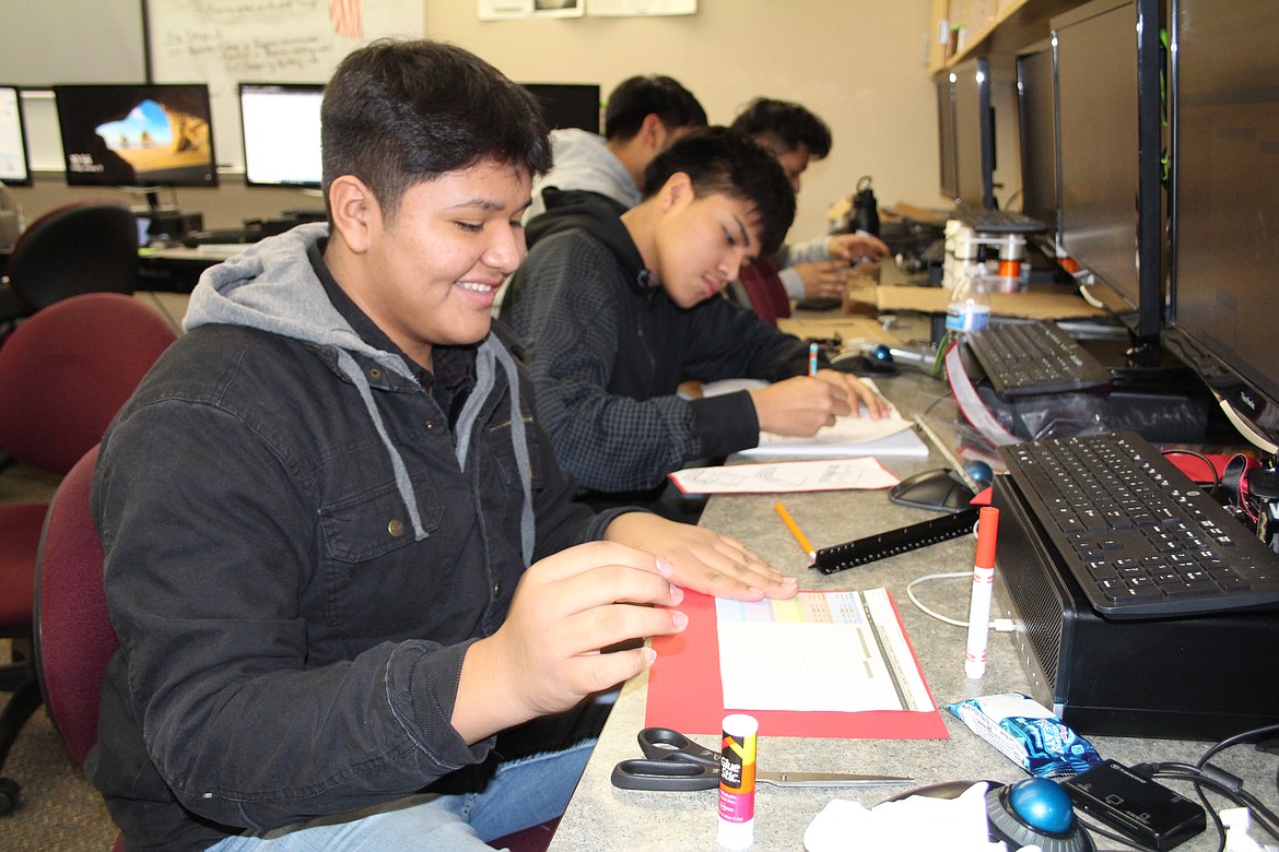 Valentin Quiroz, foreground and Bryan Sandoval, back, prepare a presentation during Friday’s Warrior Academy at Wahluke High School.