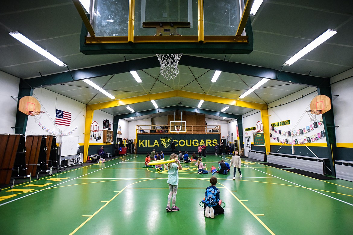 Students play a game inside the gym during a physical education class with teacher Tika Counts, who also teaches art and music, at Kila School on Wednesday, Jan. 18. (Casey Kreider/Daily Inter Lake)