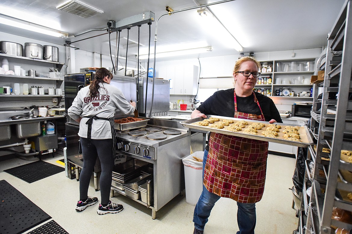 School cooks Carri Hancock, left, and Mindi Thomas work inside the kitchen at Kila School on Wednesday, Jan. 18. (Casey Kreider/Daily Inter Lake)