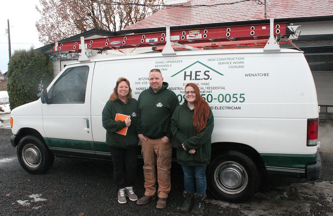 From Left: Tina Southard, James Anderson and Grace Anderson stand with a Home Electrical Services truck outside the company’s headquarters in Moses Lake. The company has built a reputation for itself by signing on to do unique electrical work.