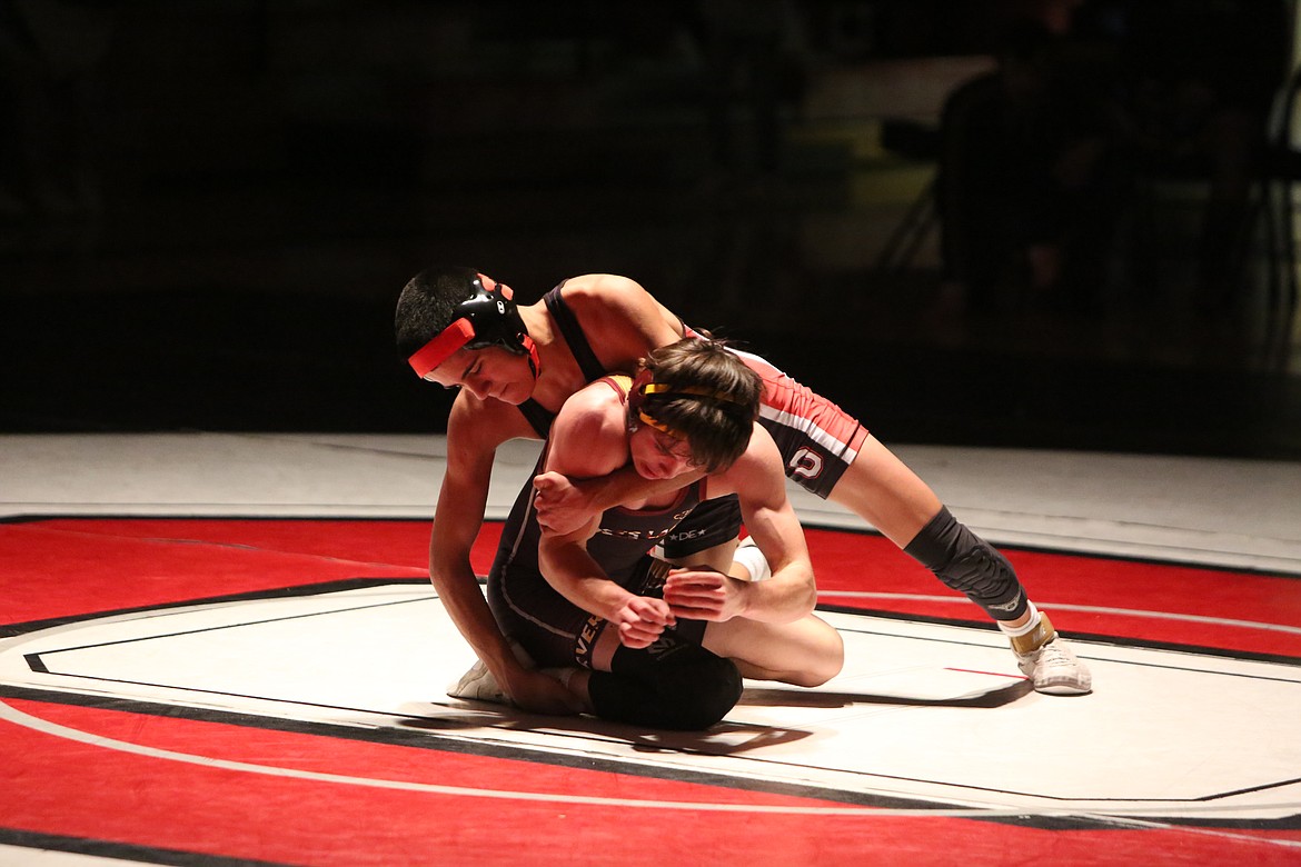 Othello freshman Daniel Gonzalez, top, won his match in the 113 weight class by a major decision on Tuesday night.