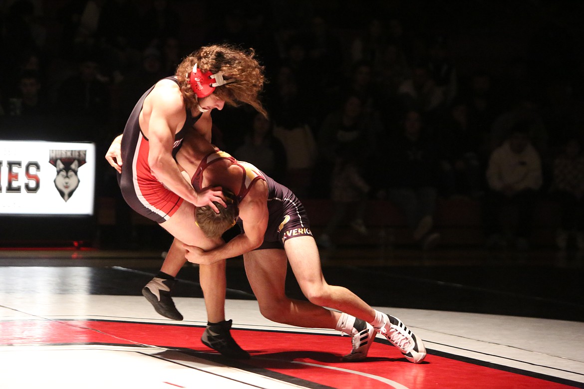 Moses Lake senior Brock Clark, right, takes down Othello’s Jaden Perez during a dual between the Huskies and Mavericks. Clark won the match in a 5-3 decision.