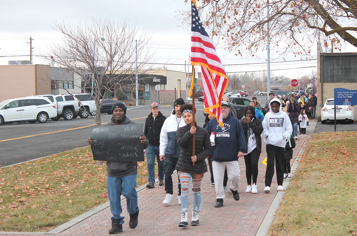 About 30 marchers, led by Deandre Jones, left, and Glory Jones, make their way to the Moses Lake Civic Center Monday for the Martin Luther King J. Day celebration. By the end of the celebration, more than 100 area residents gathered for the event.