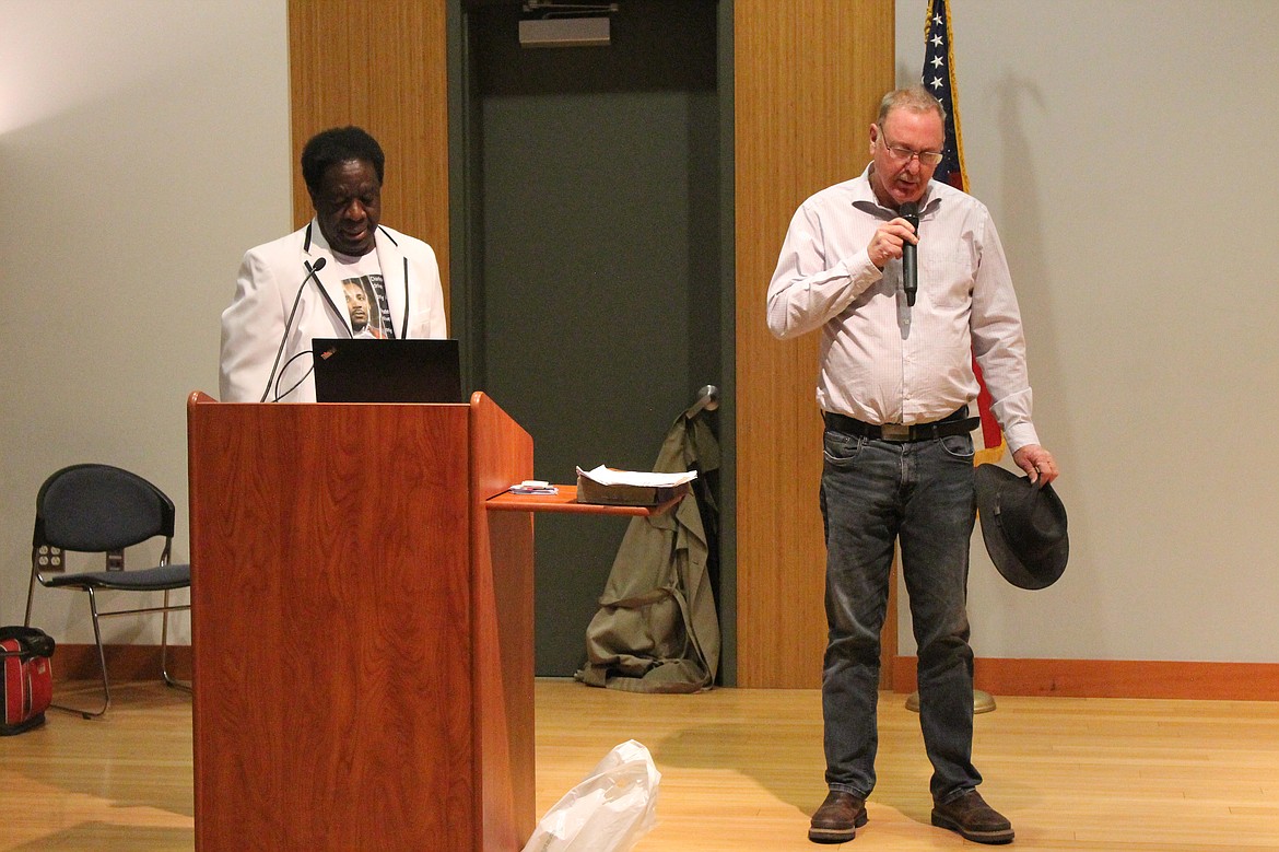 Pastor Art Brown, right, delivers the opening prayer at the Martin Luther King Jr. Day service, accompanied by committee president and emcee Charlie Jones.