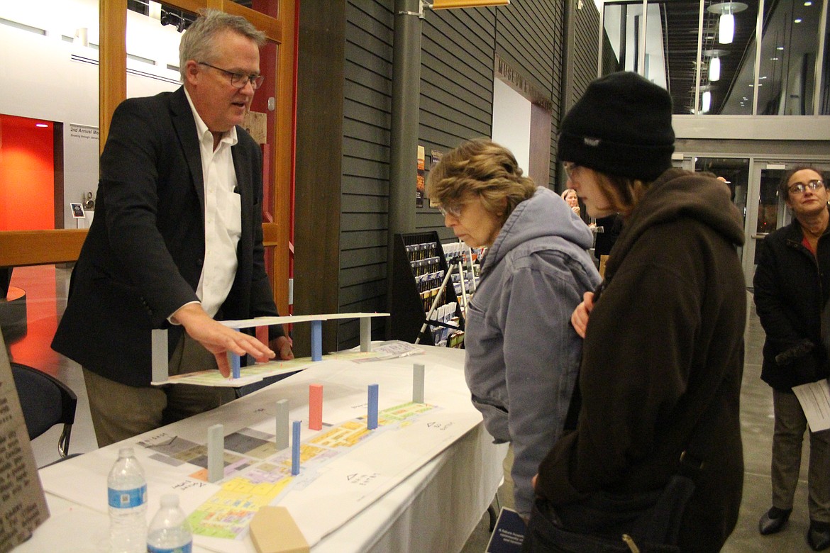 Consultant Joe Kunkel, left, shows a proposed layout of the new Samaritan Hospital to visitors at a hospital-sponsored open house Wednesday.