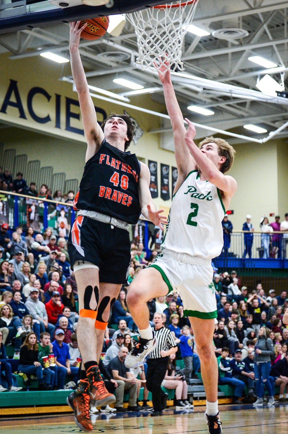 Flathead's Noah Cummings (40) goes to the basket against Glacier's Tyler McDonald (2) during crosstown basketball at Glacier High School on Friday, Jan. 20. (Casey Kreider/Daily Inter Lake)