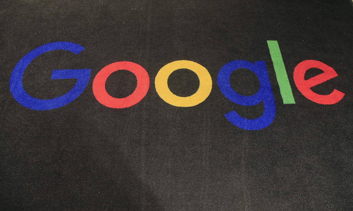 The logo of Google is displayed on a carpet at the entrance hall of Google France in Paris, on Nov. 18, 2019. Google said Friday, jan. 20, 2023, it’s laying off 12,000 workers, becoming the latest tech company to trim staff after rapid expansions during the COVID-19 pandemic have worn off. (AP Photo/Michel Euler, File)