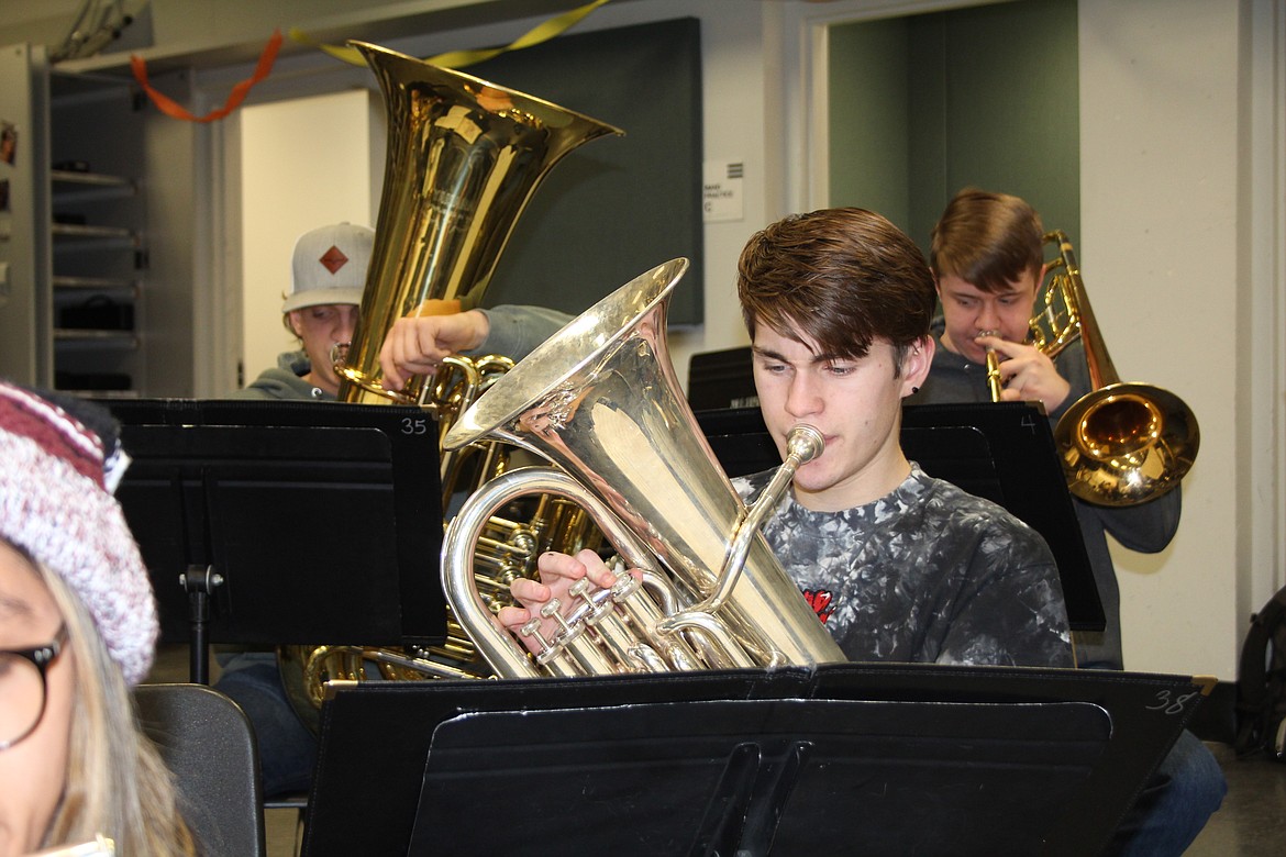 Jamisen White works to blend his sound and style with the rest of the Moses Lake High School wind ensemble during practice.